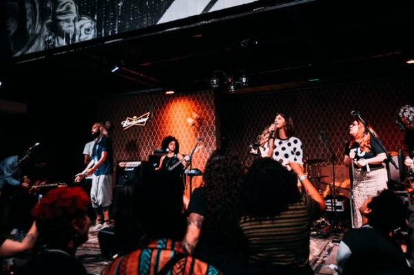 Grupo de mulheres cantando no palco